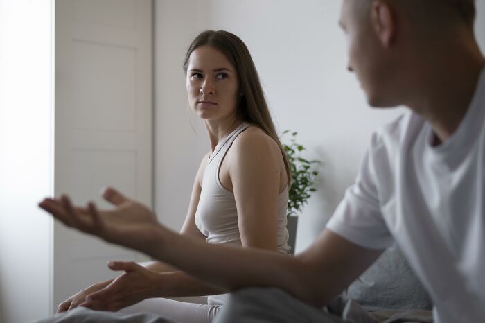 A woman looking displeased while her boyfriend talks, showing a moment a boyfriend said something they couldn't come back from.