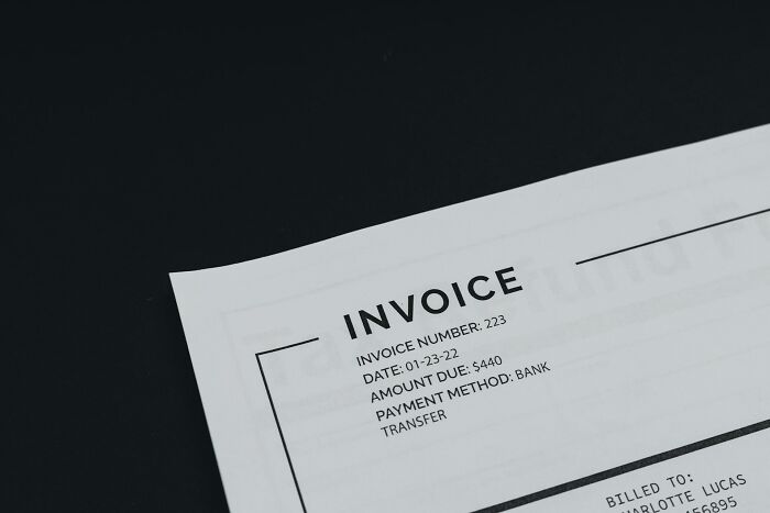 Close-up of an invoice, highlighting the financial realities and freedom that come with college life.