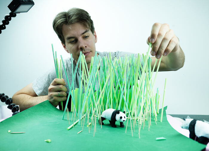 Photographer building a miniature habitat for a panda, showing how waste endangers animals. Photographer building a miniature habitat for a panda, showing how waste endangers animals.