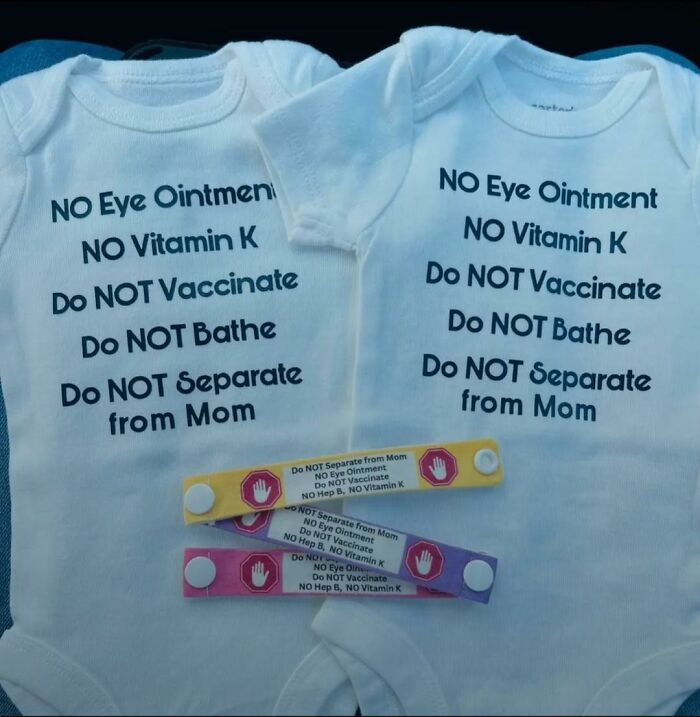 Two baby onesies and wristbands with instructions for parents not to vaccinate or give eye ointment.