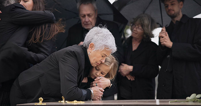 Family and friends mourn at a funeral, highlighting the grieving guy's loss before he moves in with his bro and SIL. Family and friends mourn at a funeral, highlighting the grieving guy's loss before he moves in with his bro and SIL.