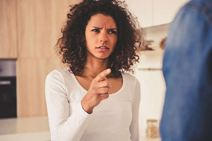 A frustrated woman pointing her finger, depicting the conflict with the grieving guy's babysitting service expectation. A frustrated woman pointing her finger, depicting the conflict with the grieving guy's babysitting service expectation.