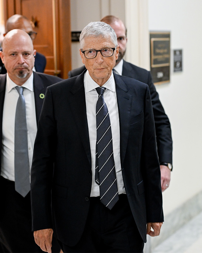 Bill Gates walking with security, facing scrutiny over his daughter's startup fraud allegations that could carry a prison sentence.
