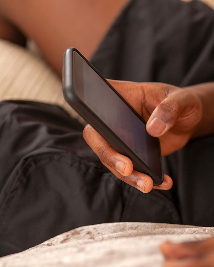 Close-up of a hand holding a smartphone, relating to the fraud accusation and potential prison sentence for Bill Gates daughter's startup.