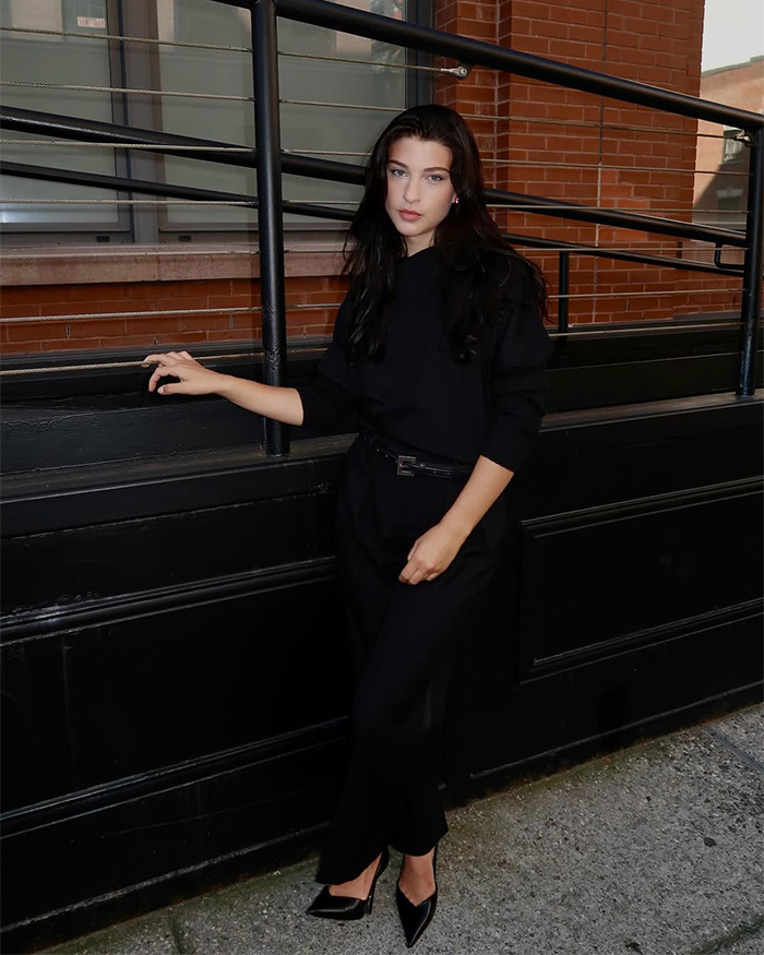 Bill Gates daughter posing in a black outfit, connected to startup fraud accusations and a potential prison sentence.