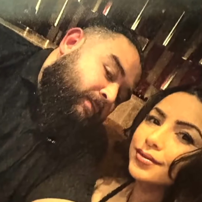 A couple smiling for a selfie, linked to bizarre cruise ship incidents involving a Foot Fungus Lady that terrified tourists.