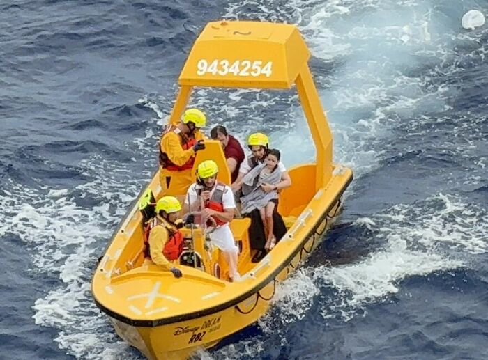A yellow rescue boat in the ocean with people aboard, referencing bizarre cruise ship incidents and the Foot Fungus Lady.