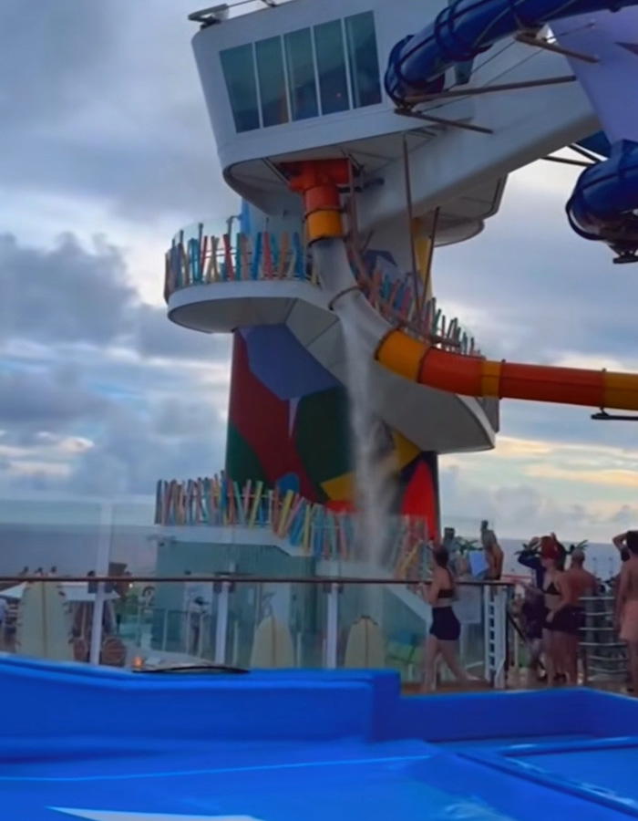 Cruise ship incident showing a water slide discharging water on deck, adding to bizarre cruise ship events.