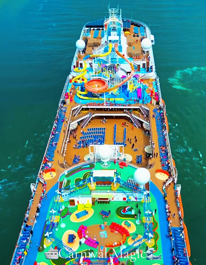 An aerial view of a vibrant Carnival Magic cruise ship with water slides and pools, highlighting cruise ship incidents.