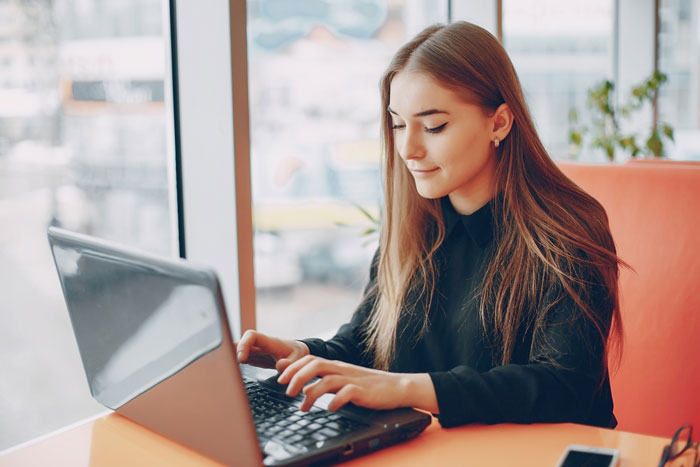 A woman on a laptop, representing the ex-girlfriend sending receipts to expose lies. A woman on a laptop, representing the ex-girlfriend sending receipts to expose lies.
