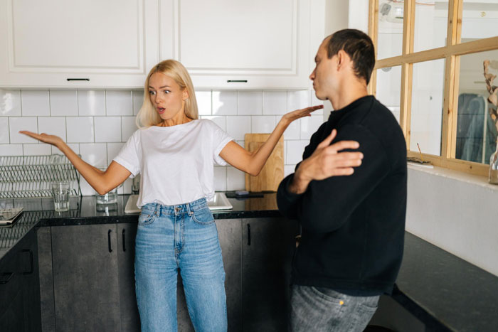 Woman gesturing in frustration at a man, reflecting the tension of friends playing each other. Woman gesturing in frustration at a man, reflecting the tension of friends playing each other.