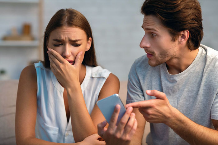 A girl crying while a guy points at a phone, reflecting the story of him calling his dream girl chubby and trying to fix her. A girl crying while a guy points at a phone, reflecting the story of him calling his dream girl chubby and trying to fix her.