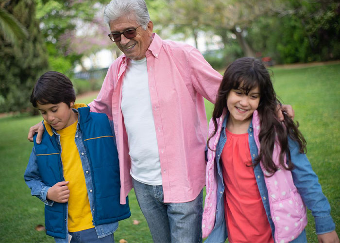 A man with his children walking outdoors, highlighting the relationship with children. A man with his children walking outdoors, highlighting the relationship with children.