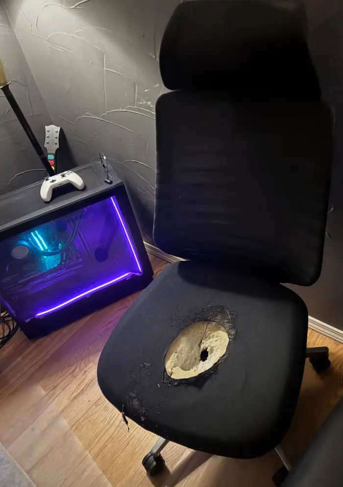 A worn-out chair with a hole in the seat next to a gaming PC, symbolizing reasons for choosing a cat lady lifestyle over relationships.