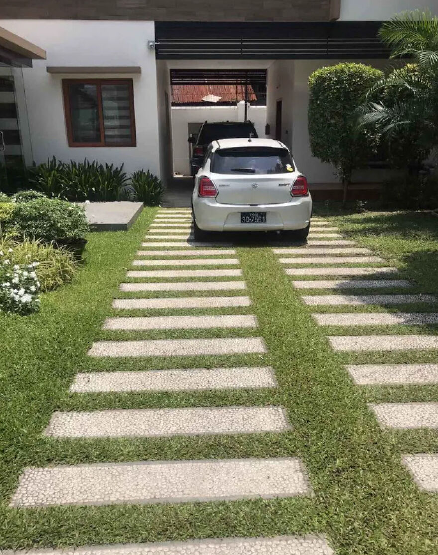 A small white car parked on a modern driveway with stepping stones, illustrating spaces for side hustles.