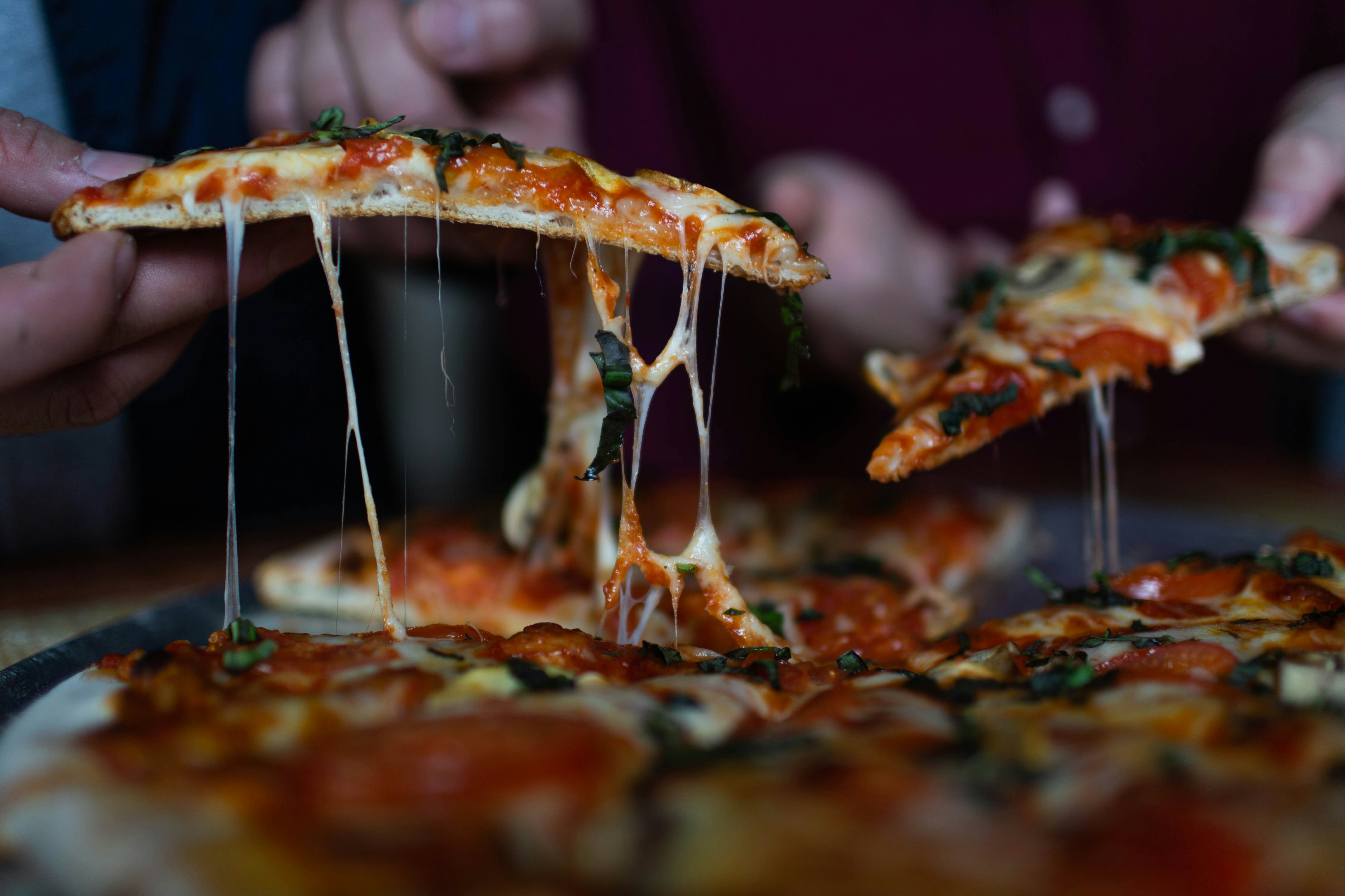 Close-up of a pizza slice, symbolizing the wedding guests' hunger fight and quest for dinner beyond appetizers. Close-up of a pizza slice, symbolizing the wedding guests' hunger fight and quest for dinner beyond appetizers.