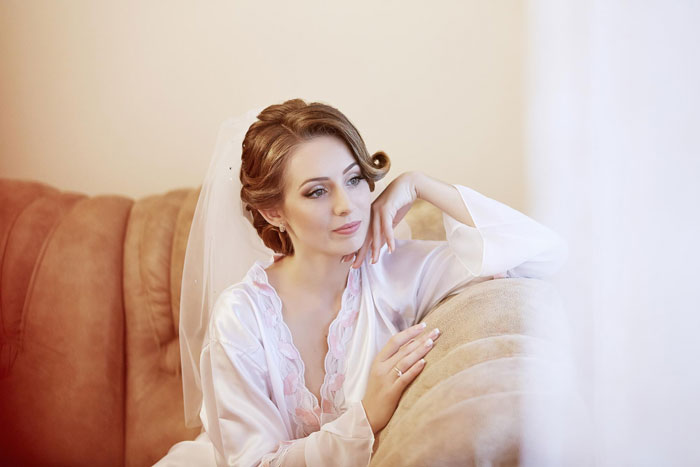 A woman in a white robe and veil, happy her toxic sis is infertile, relaxing on a couch, contemplating her sister's inability to damage a kid. A woman in a white robe and veil, happy her toxic sis is infertile, relaxing on a couch, contemplating her sister's inability to damage a kid.