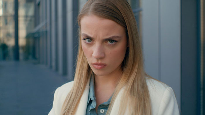 A woman with a stern expression, reflecting anger or frustration about her toxic sister and her infertility. A woman with a stern expression, reflecting anger or frustration about her toxic sister and her infertility.