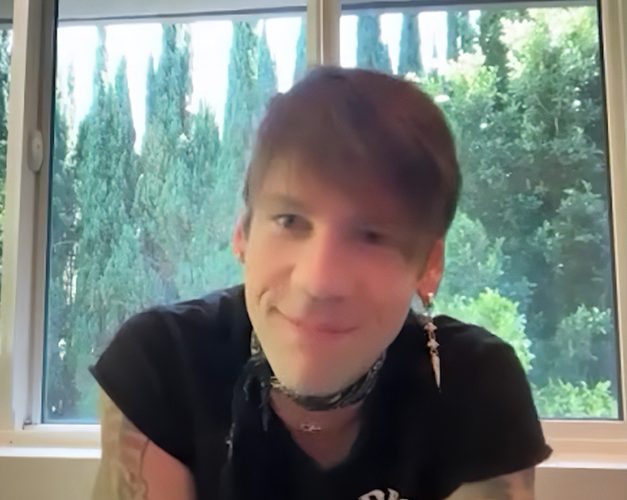 Smiling rock star after coming out as gay, looking comfortable and happy.