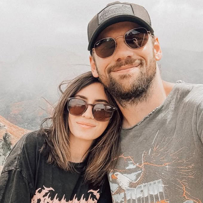 Smiling rock star and his wife in sunglasses, reflecting on his coming out as gay and 14-year marriage.