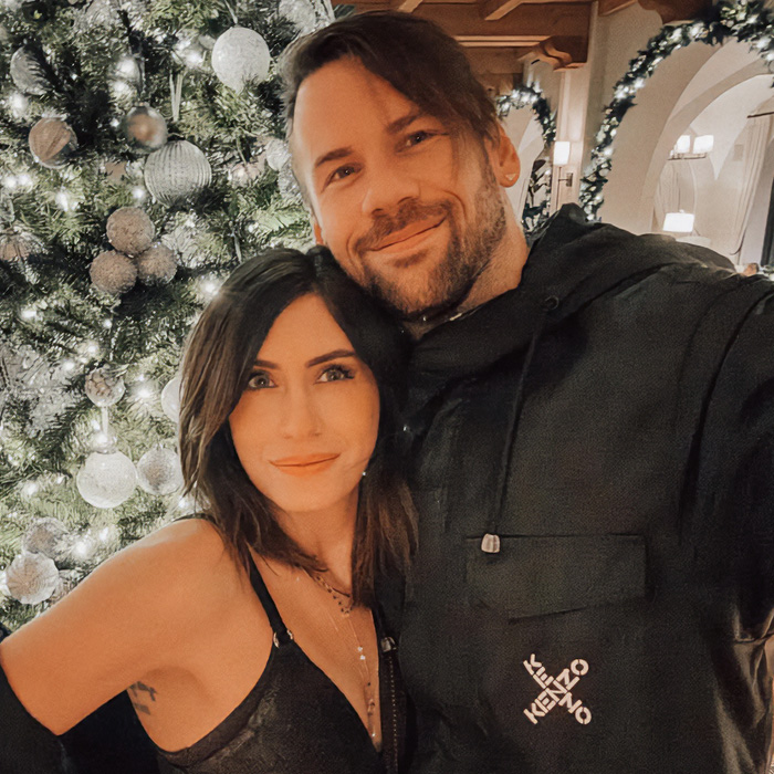 Rock star and his wife smiling by a Christmas tree, prior to his coming out as gay and 14-year marriage.