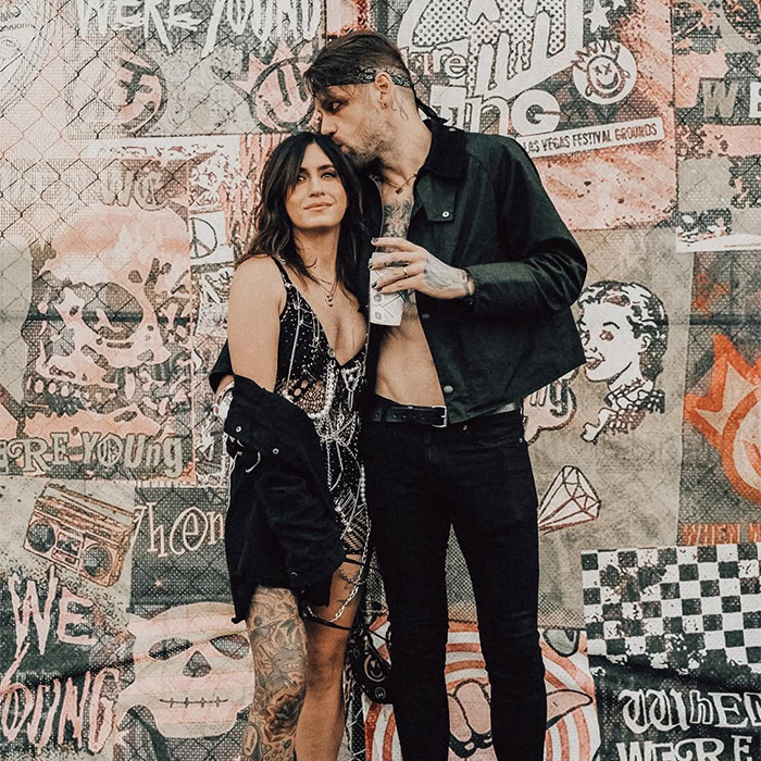 Rock star and his wife against a graffiti wall, before his coming out as gay and 14-year marriage revelation.