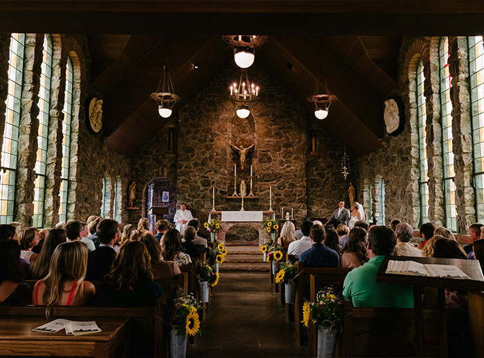 A Christian wedding ceremony in a stone church, with guests seated, highlighting a bride's journey regarding marriage advice. A Christian wedding ceremony in a stone church, with guests seated, highlighting a bride's journey regarding marriage advice.