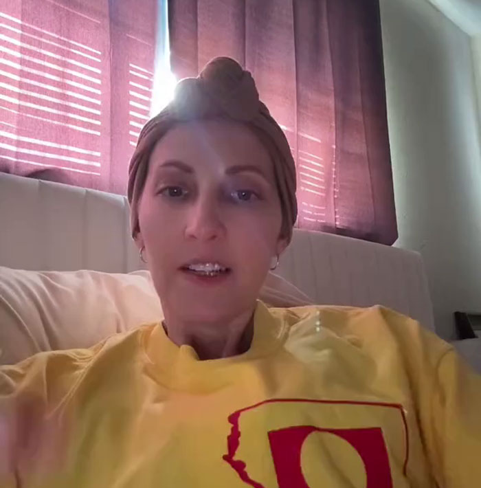 A TikToker in a yellow sweatshirt, filming her goodbye video, sharing her final message with millions. A TikToker in a yellow sweatshirt, filming her goodbye video, sharing her final message with millions.