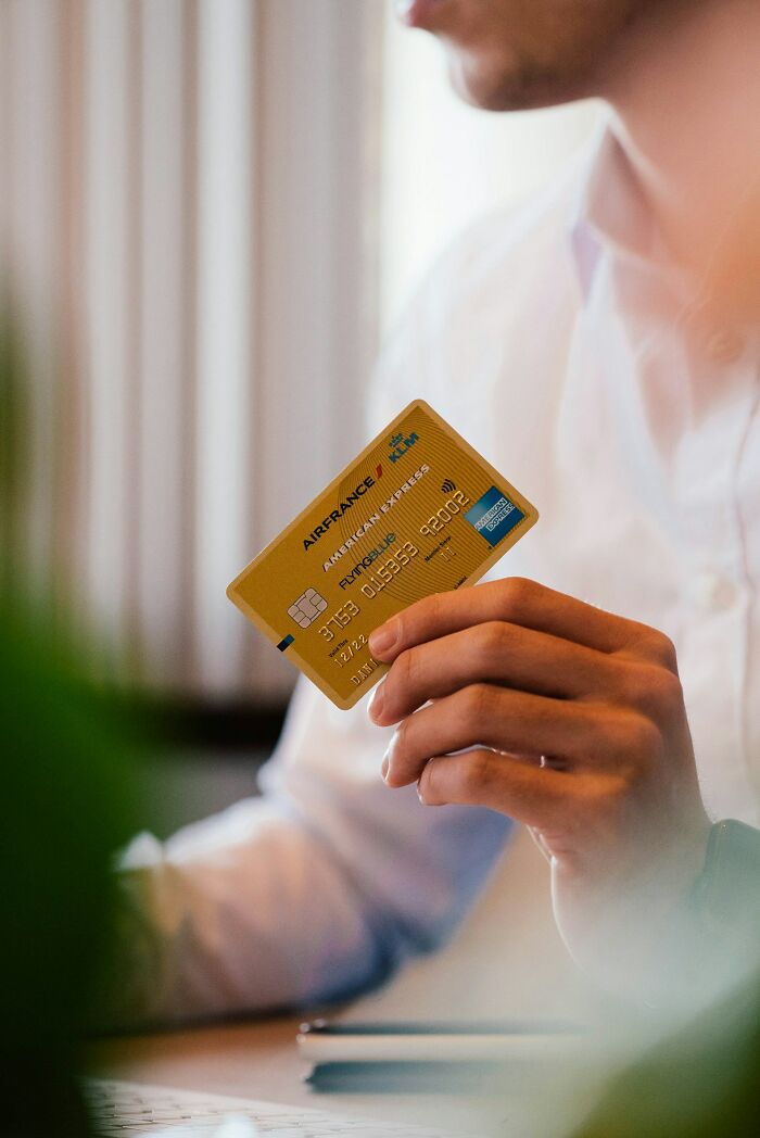 A person holds a credit card. Horrible parent.