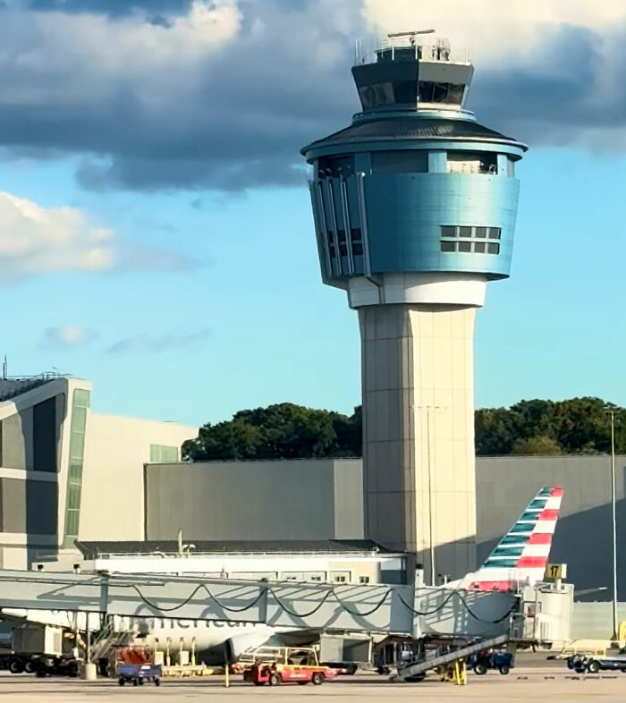 An air traffic control tower overseeing an airport, symbolizing the role of air traffic controllers in preventing crashes. An air traffic control tower overseeing an airport, symbolizing the role of air traffic controllers in preventing crashes.
