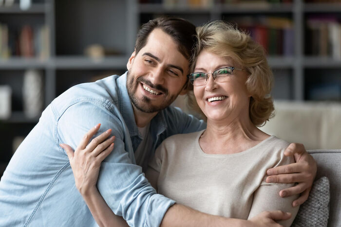 A man embracing a woman, both smiling, highlighting complex reasons behind affair partners.