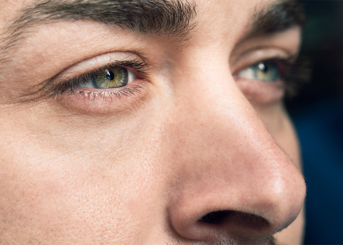 A close-up of a human eye, depicting the new color Olo as a unique hue in the iris.