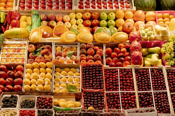 A vibrant display of fresh fruits in a market, showcasing diverse produce. Learn insider knowledge from different industries.
