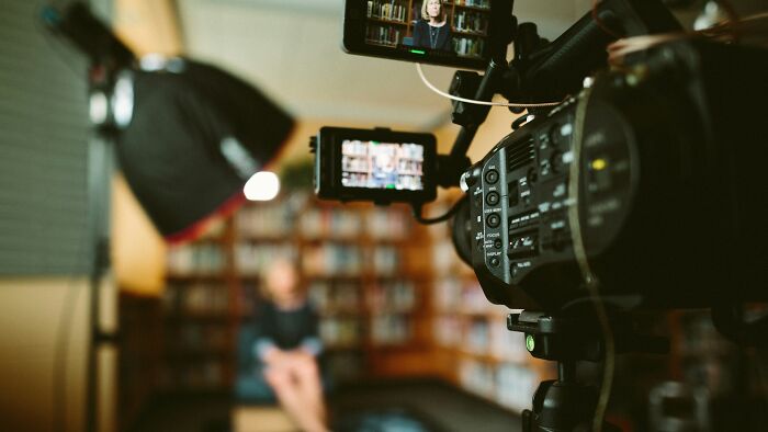 A video camera focused on an interview, capturing insider knowledge from different industries.