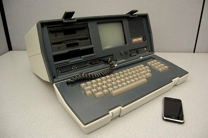 A vintage portable computer next to a modern smartphone, illustrating how technology led companies to ruin.