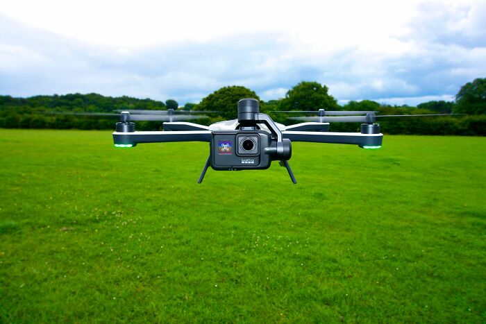A drone with a camera hovers over a green field, representing companies that used to dominate the market.