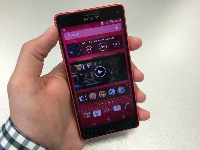 A hand holding a Sony smartphone, symbolizing companies that used to dominate the market.