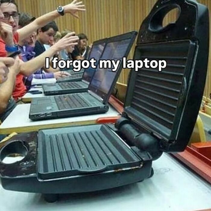 A student with a George Foreman grill instead of a laptop in a classroom, demonstrating a dumb person. 