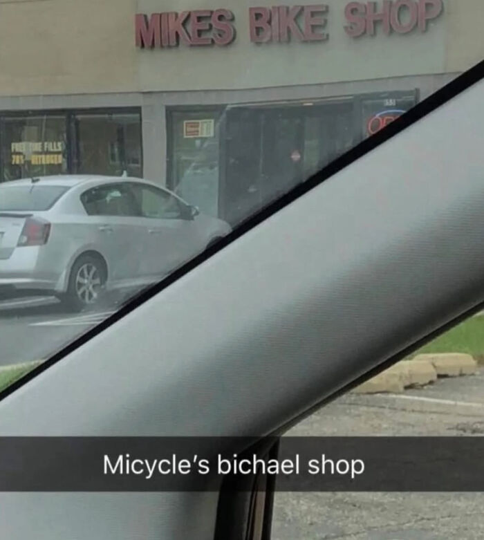 A sign for Mikes Bike Shop, humorously mistyped as Micycles Bichael Shop, an example of dumb people on the internet.