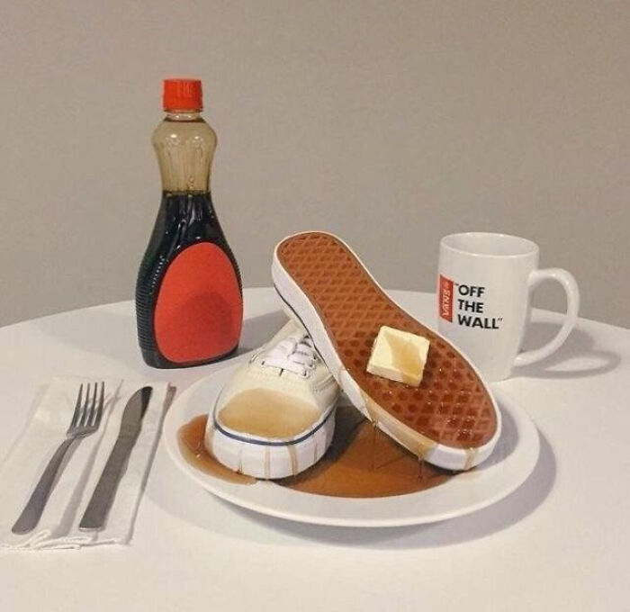 Vans shoes on a plate with syrup and butter, resembling pancakes, a pic people cannot explain.