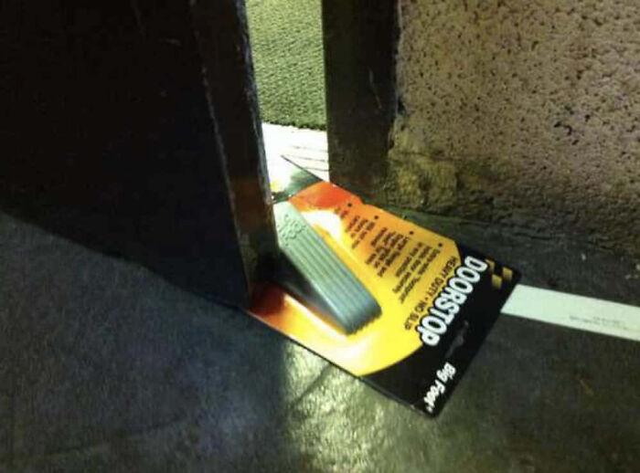 A doorstop still in its packaging, holding a door open, an unexplainable pic that people cannot explain.