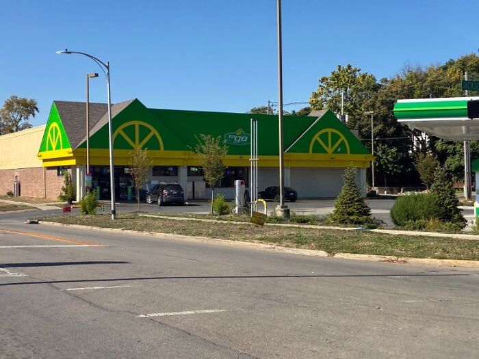 A green and yellow QuickChek store, a building pretending to be something else, resembling a lemon with a gas station nearby.