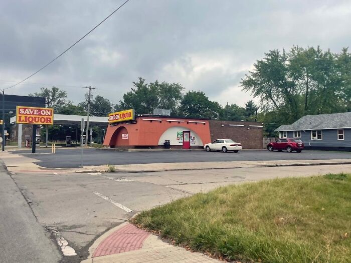A red-orange building labeled Salsitas Mexican Grill, a building pretending to be something else, with a Save-On Liquor sign in the background.