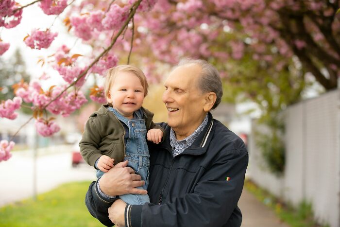 Teachers were terrified of students, contrasted with a happy elderly man holding a baby outdoors under cherry blossoms.