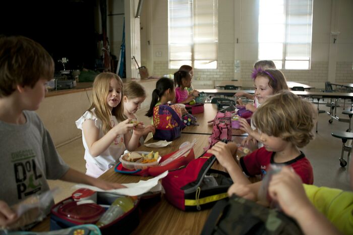 Children eating lunch at school, a scene that can relate to times teachers were terrified of students.