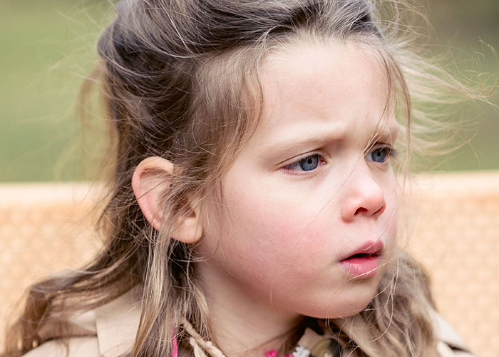 A young girl with blue eyes and a concerned expression, illustrating wild ways women caught their soulmates cheating.