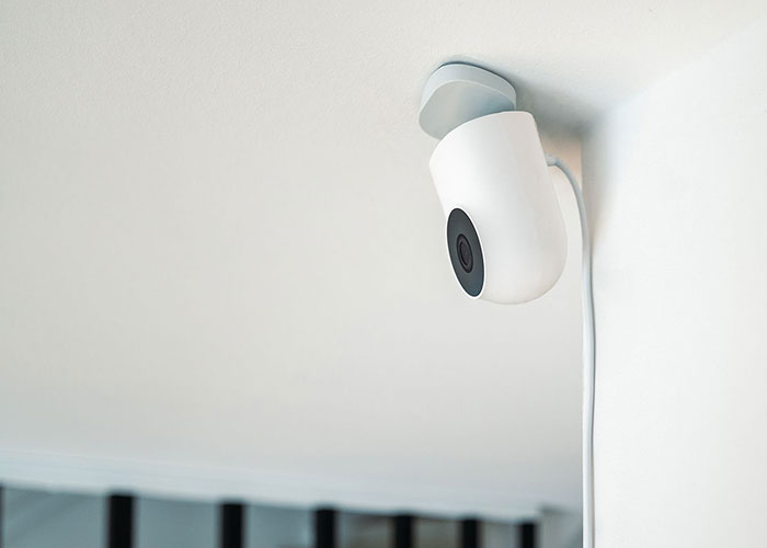 A security camera on a white ceiling, representing ways women caught their soulmates cheating.