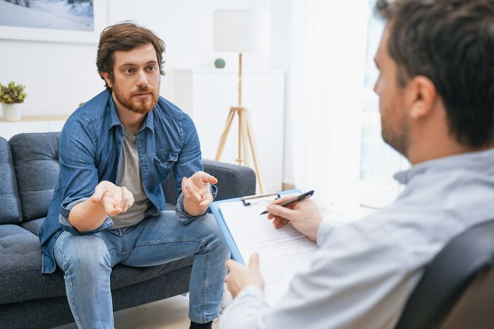 Man speaking to a doctor in a consultation, reflecting conversations with doctors.