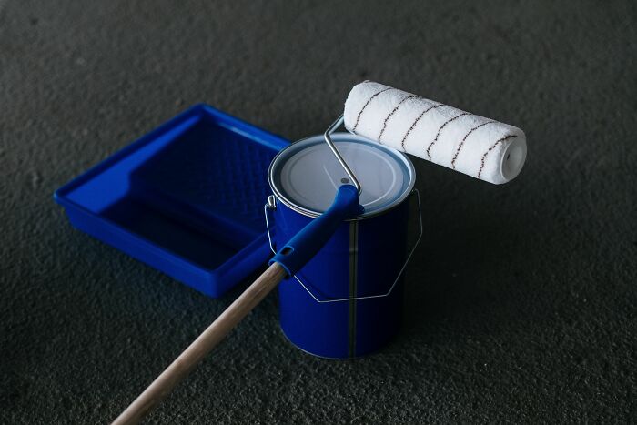 Paint can, roller, and tray, hinting at claw marks or unusual home renovations from strange experiences.