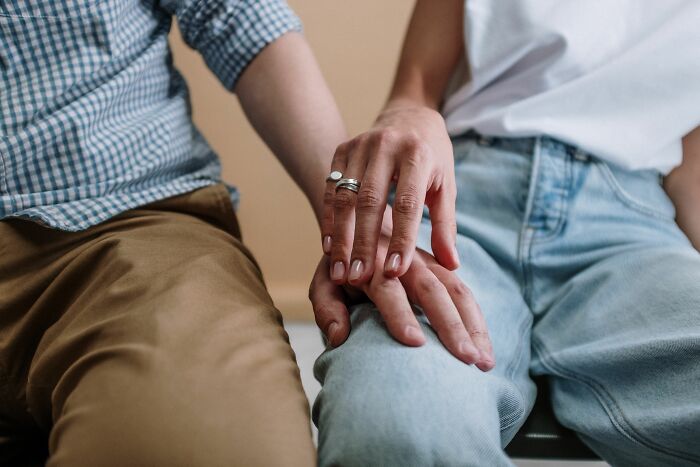 Two people holding hands, a tender moment that counters strange experiences and makes people shiver less.